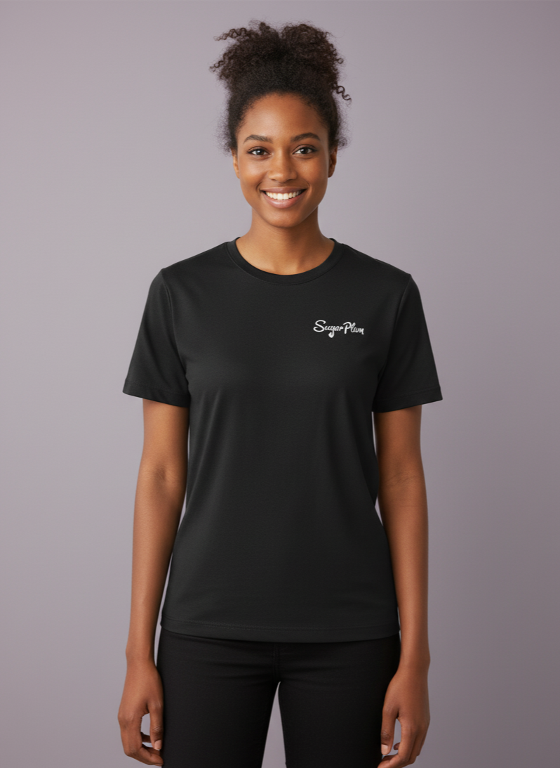 Woman wearing a black t-shirt with a logo on a gray background